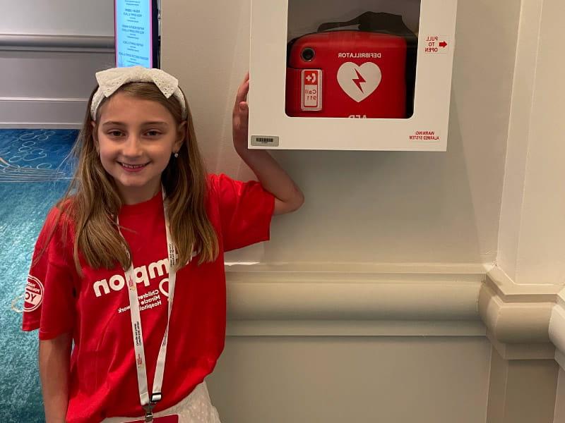 9-year-old Adeline Dinin has long QT syndrome, an electrical problem with the heart. She is known as @AED__Girl online and carries her own automated external defibrillator with her. (Photo courtesy of the Dinin family)